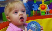 Baby holding ball.