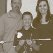 Chance Paxton with his parents proudly displays his “arrow of light" award.